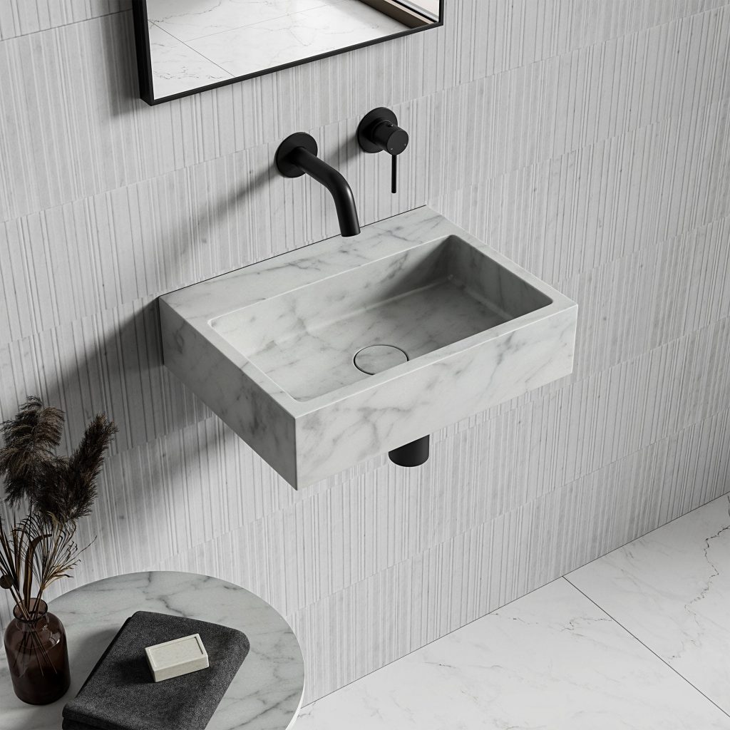 Modern stone basin with black taps and black mirror hanging above 
